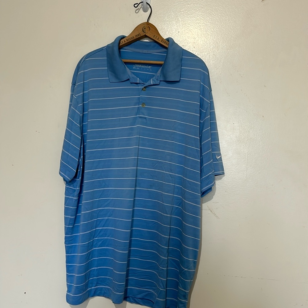 Nike men’s light blue golf shirt. Missing top button.